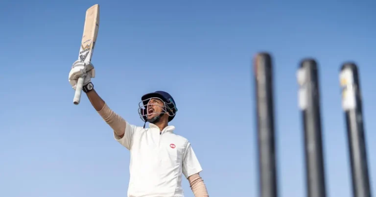 Young cricketer in Ranchi holding a cricket bat raised high, ready to play or celebrate during practice